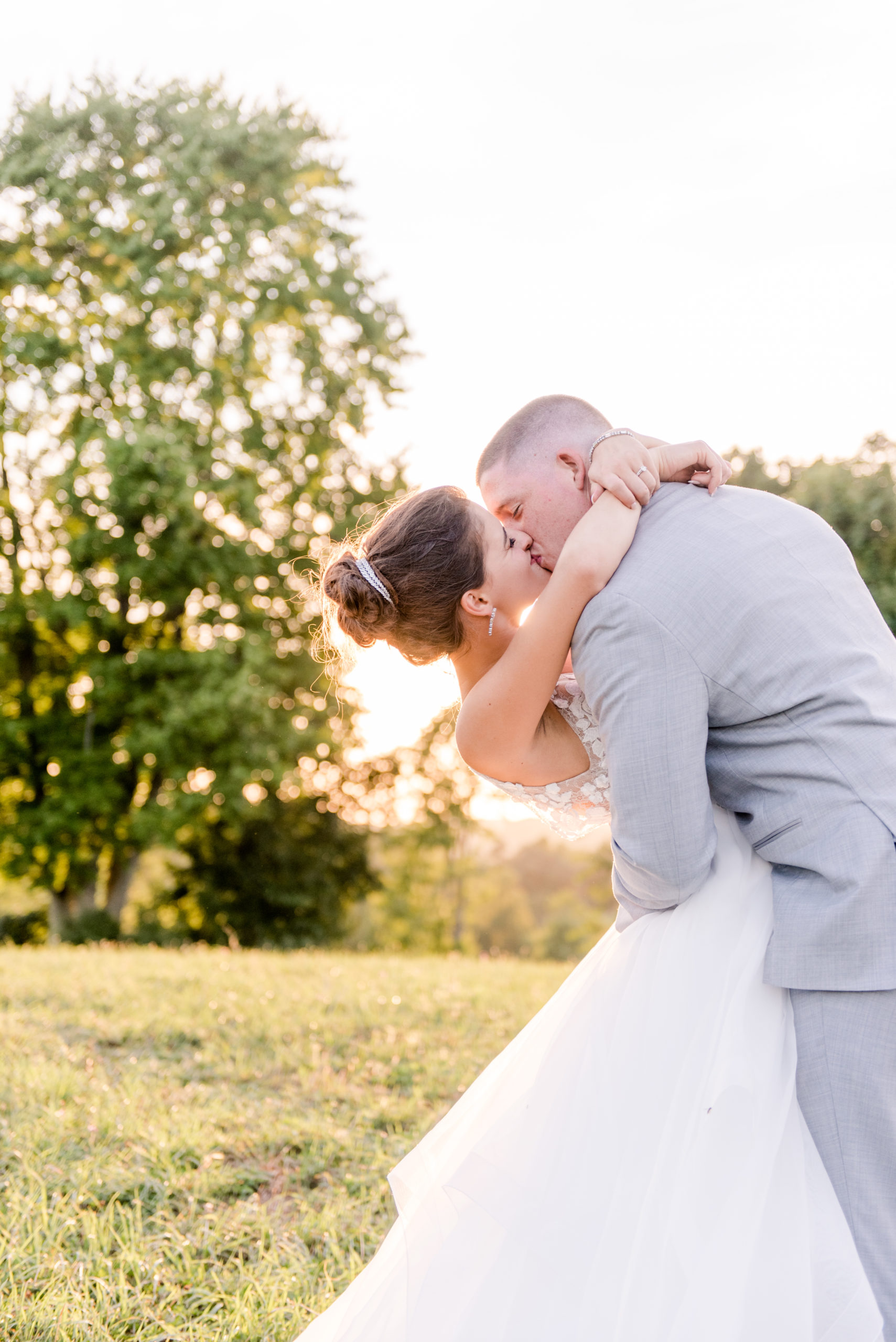 Bride and Groom kissing at sunset at Rivercrest Farm in Dover, OH