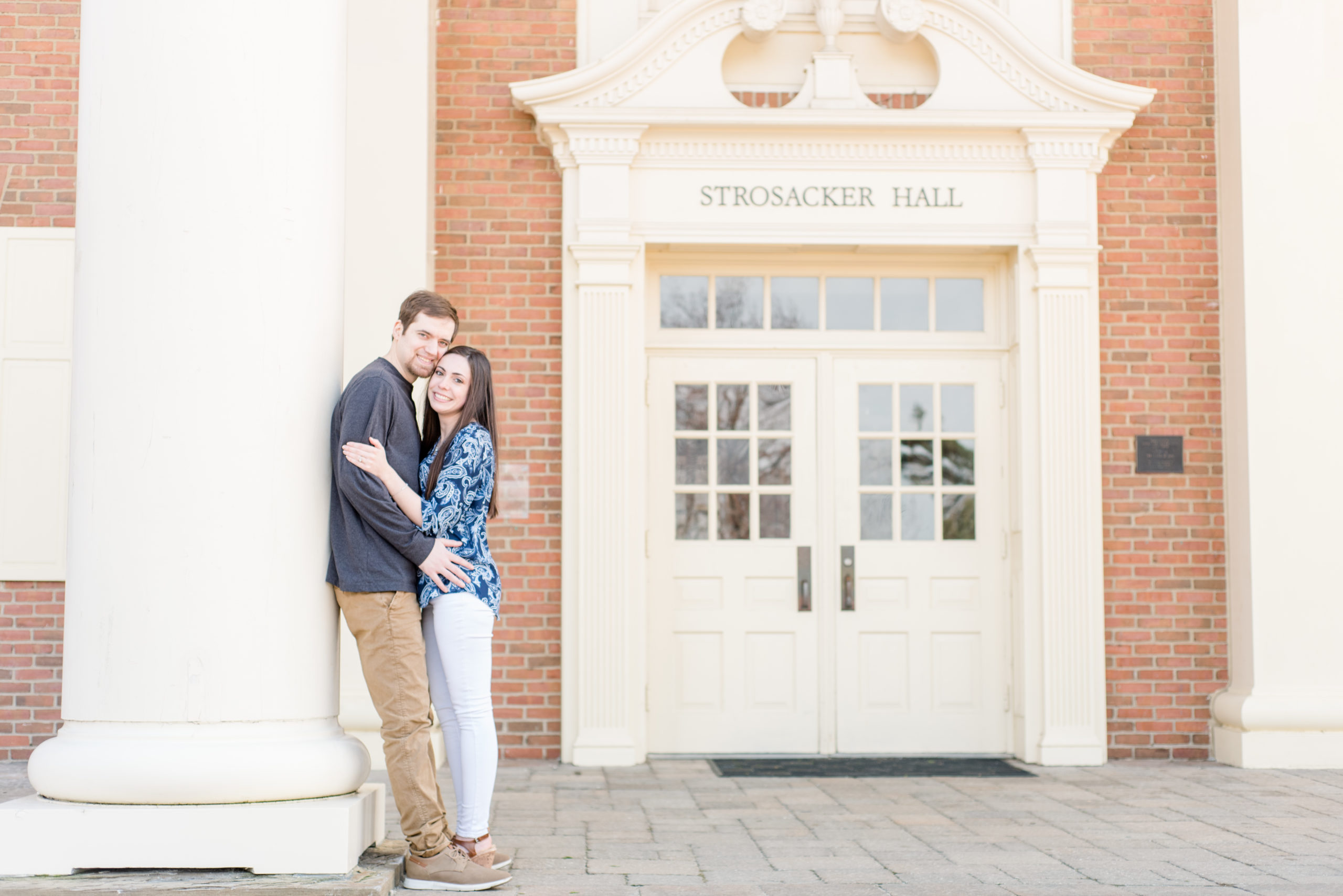 Couple embracing in front of the student union at Baldwin Wallace University
