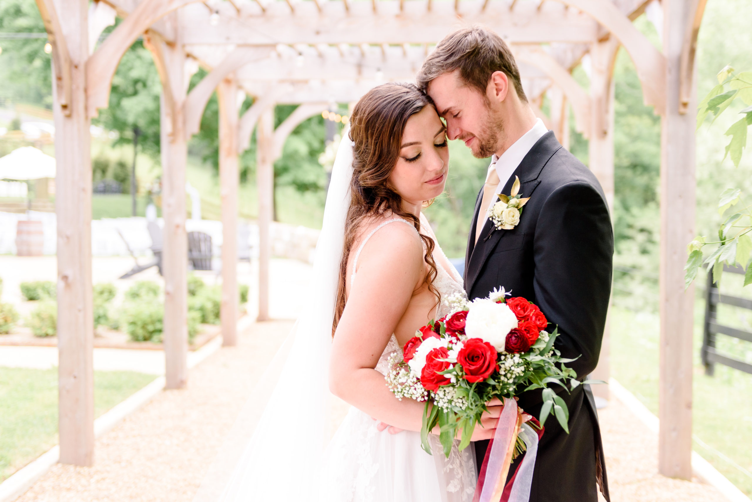 Bride and groom embrace at Rivercrest Farm in Dover Ohio