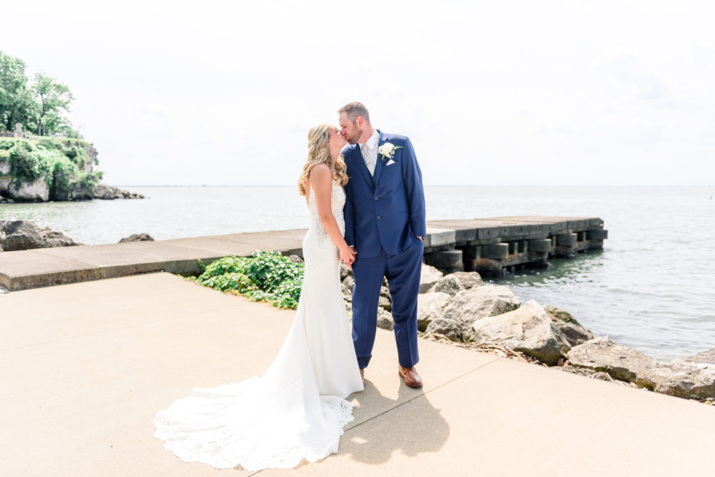 A bride and groom kissing along Lake Erie at Catawba Island Club